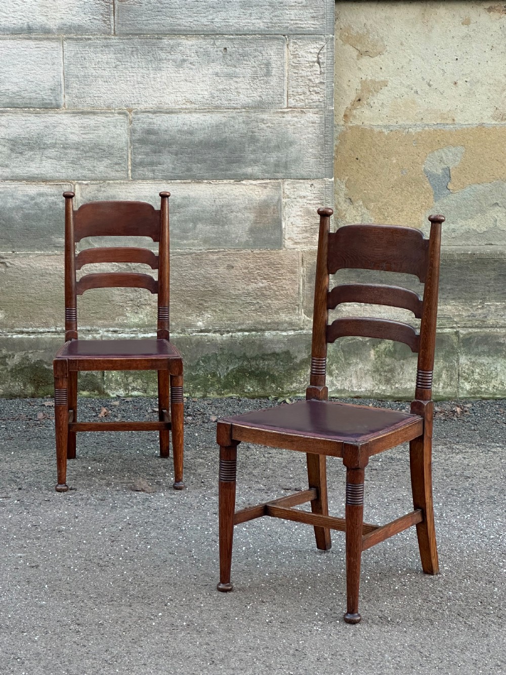 A pair of English Arts and Crafts oak side chairs by William Birch Ltd. c.1900 View V
