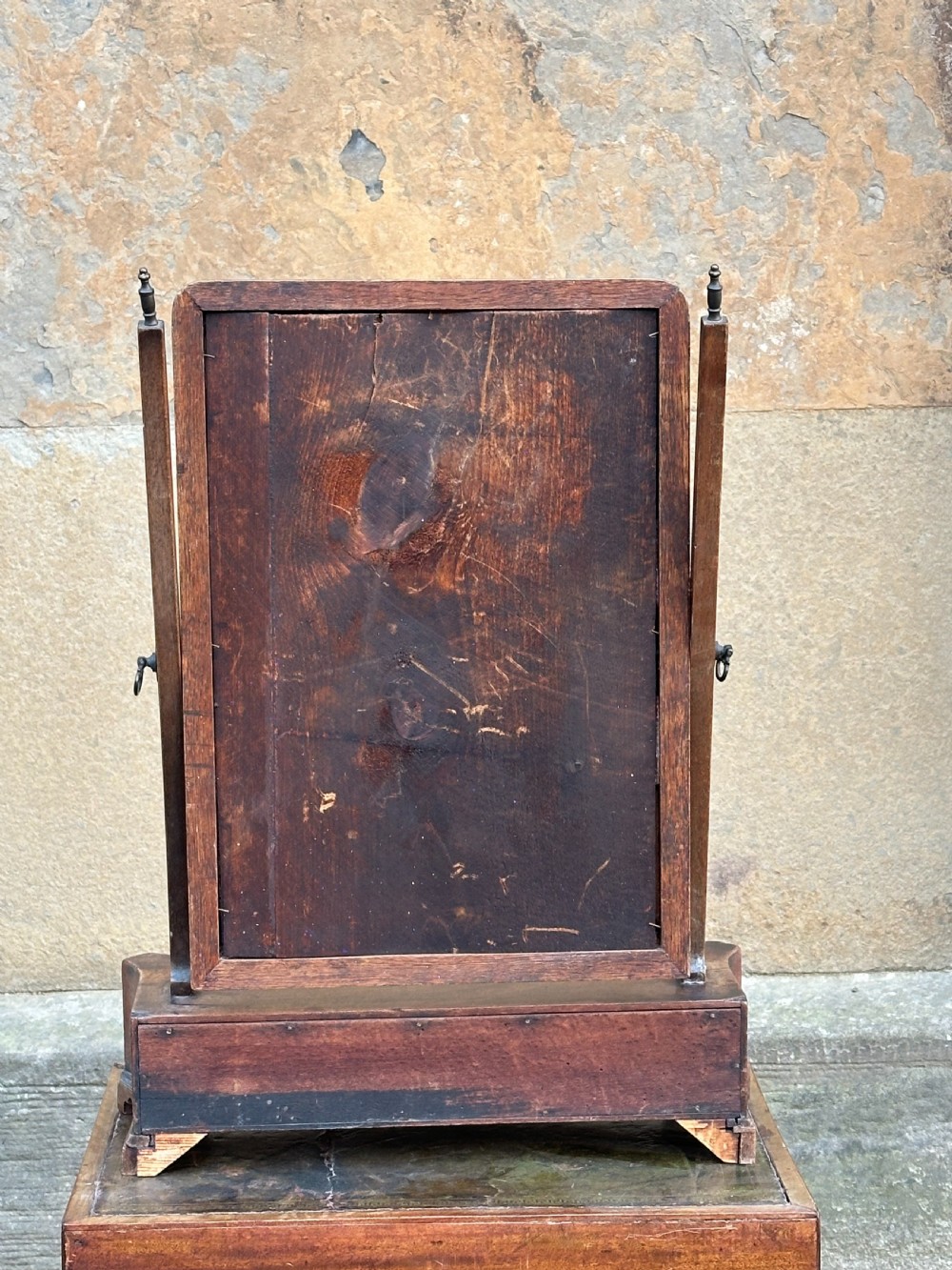 A mid-18th-century George II mahogany toilet mirror with a rectangular swing glass supported by side uprights above a drawers base. View IV