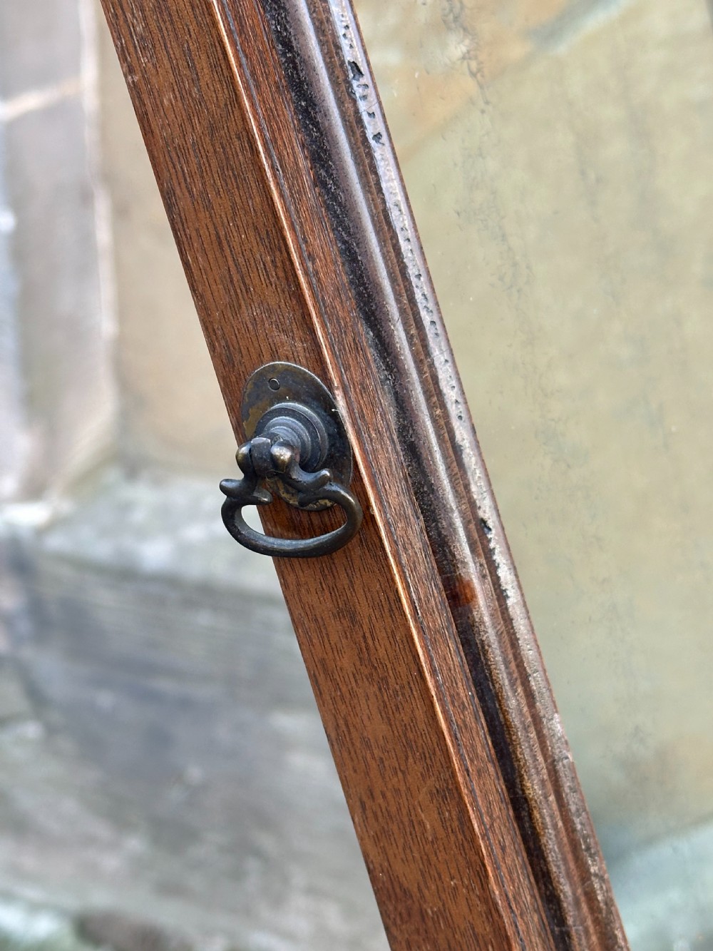 A mid-18th-century George II mahogany toilet mirror with a rectangular swing glass supported by side uprights above a drawers base. View VI