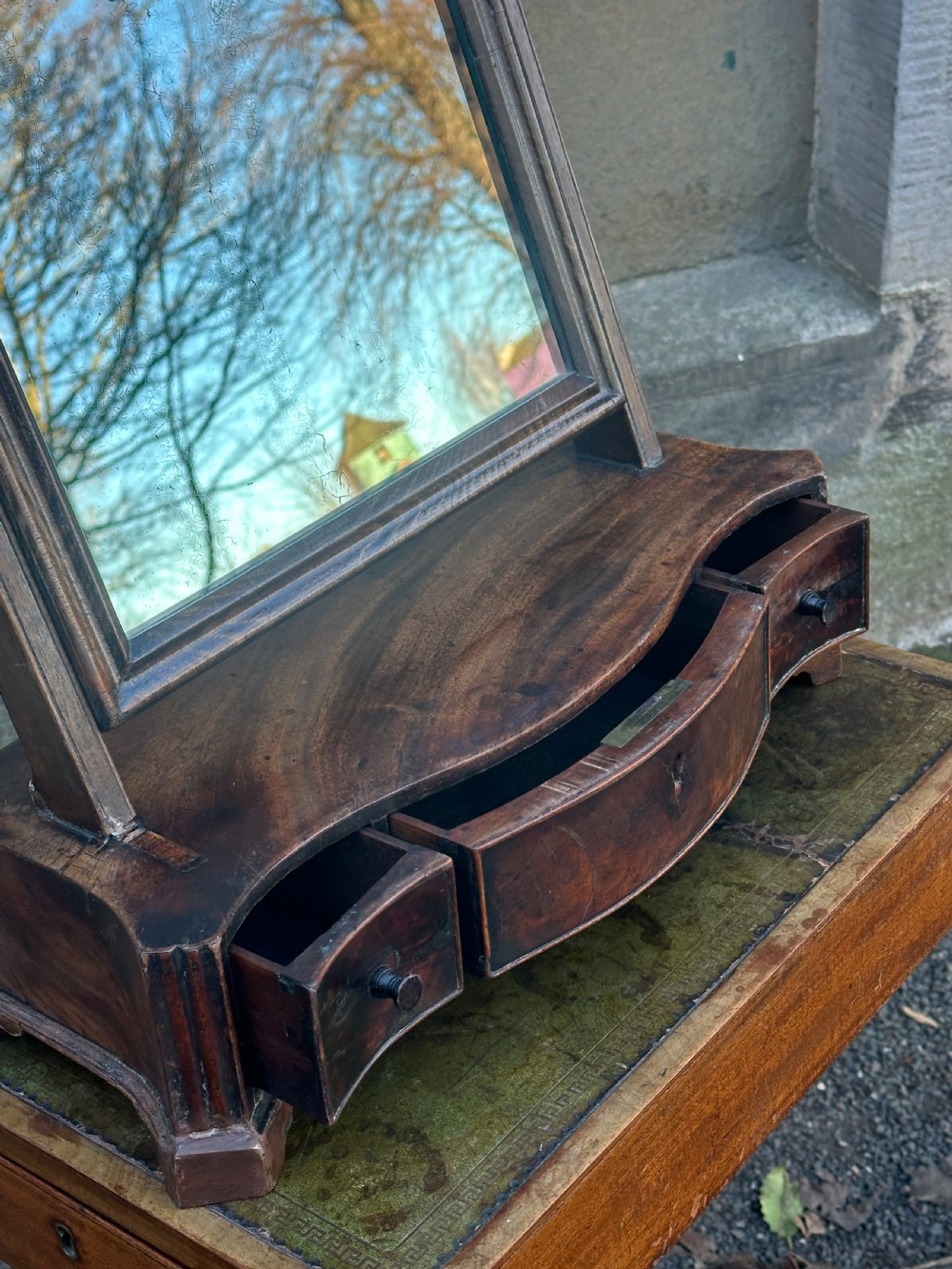 A mid-18th-century George II mahogany toilet mirror with a rectangular swing glass supported by side uprights above a drawers base. View VII