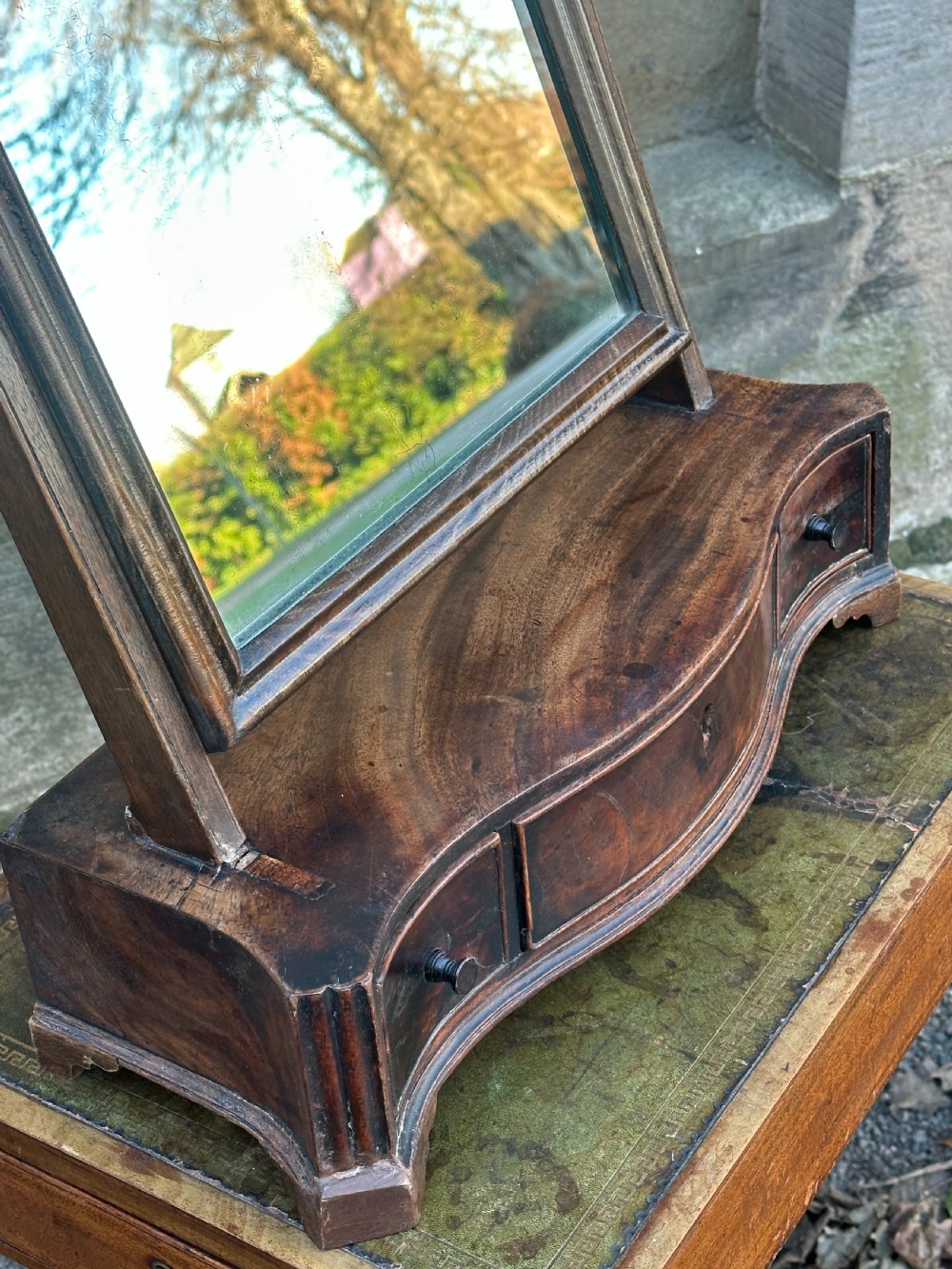 A mid-18th-century George II mahogany toilet mirror with a rectangular swing glass supported by side uprights above a drawers base. View IX