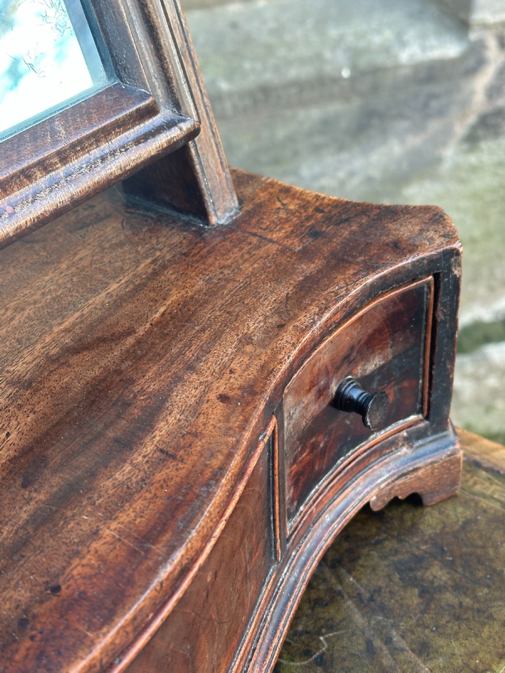 A mid-18th-century George II mahogany toilet mirror with a rectangular swing glass supported by side uprights above a drawers base. View XI