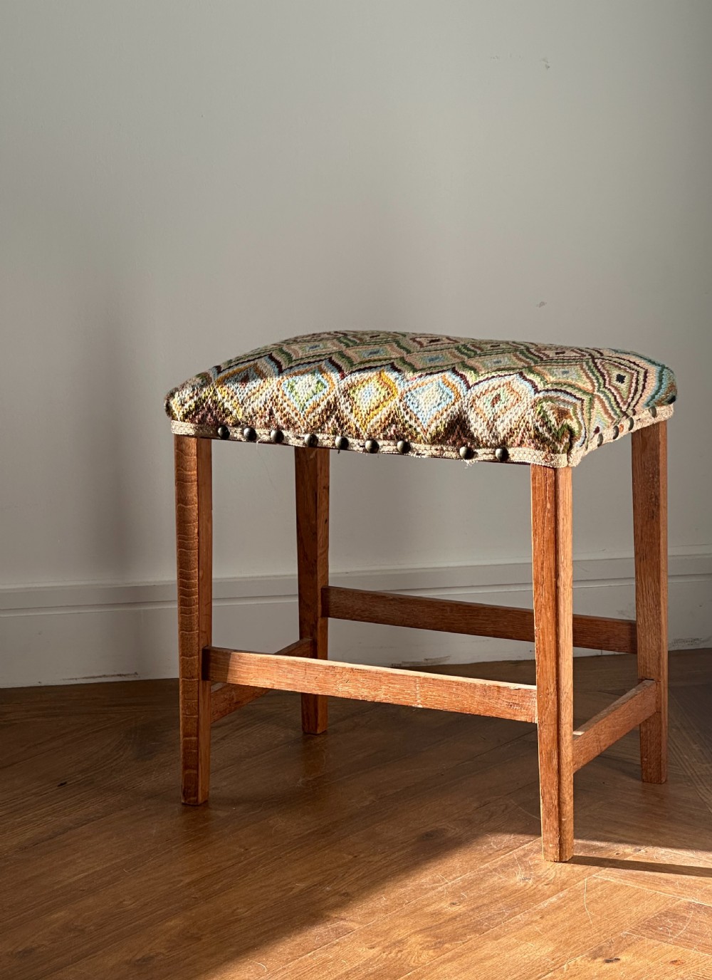 A Scottish oak framed stool, possibly by William Wheeler of Arncroach, early 20th century
