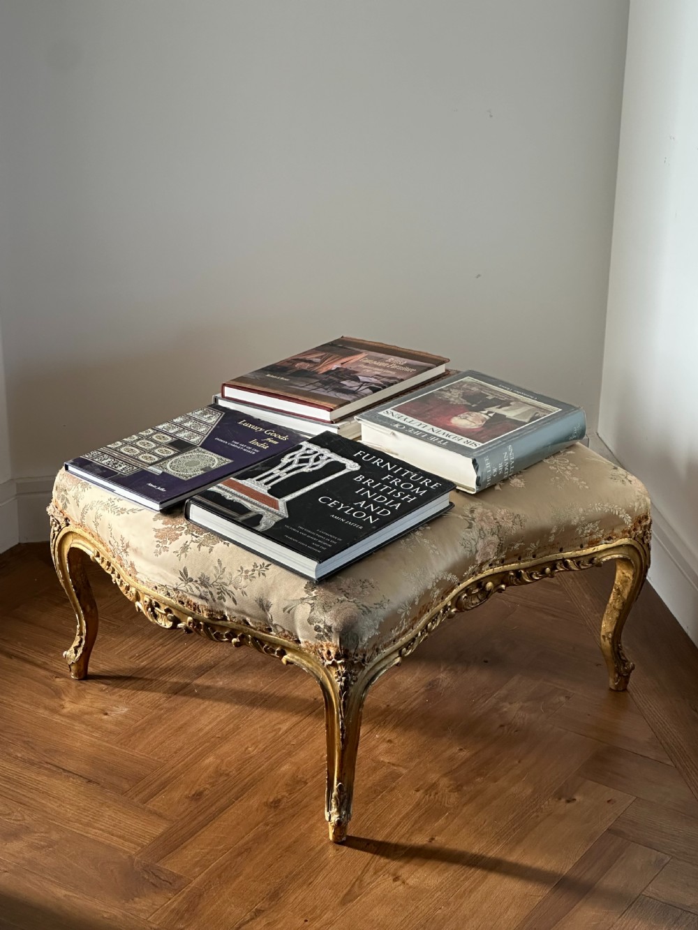 A 19th-century French giltwood centre stool featuring carved Rococo scrollwork, cabriole legs, and floral upholstered seating. View VIII