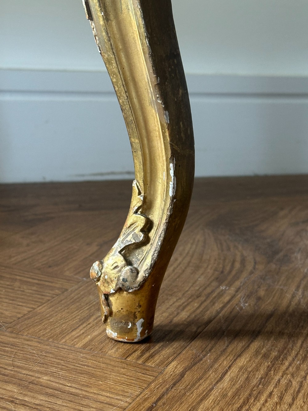 A 19th-century French giltwood centre stool featuring carved Rococo scrollwork, cabriole legs, and floral upholstered seating. View IX