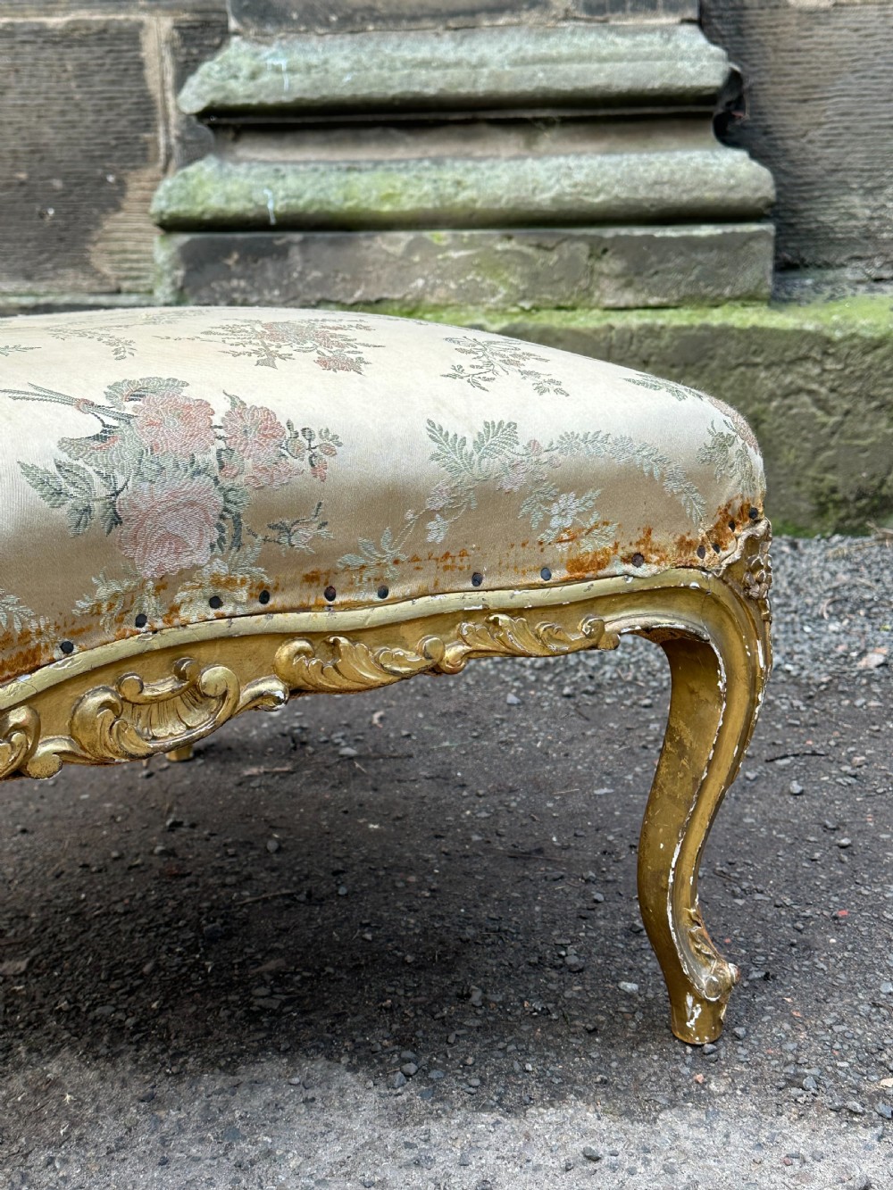 A 19th-century French giltwood centre stool featuring carved Rococo scrollwork, cabriole legs, and floral upholstered seating. View XII