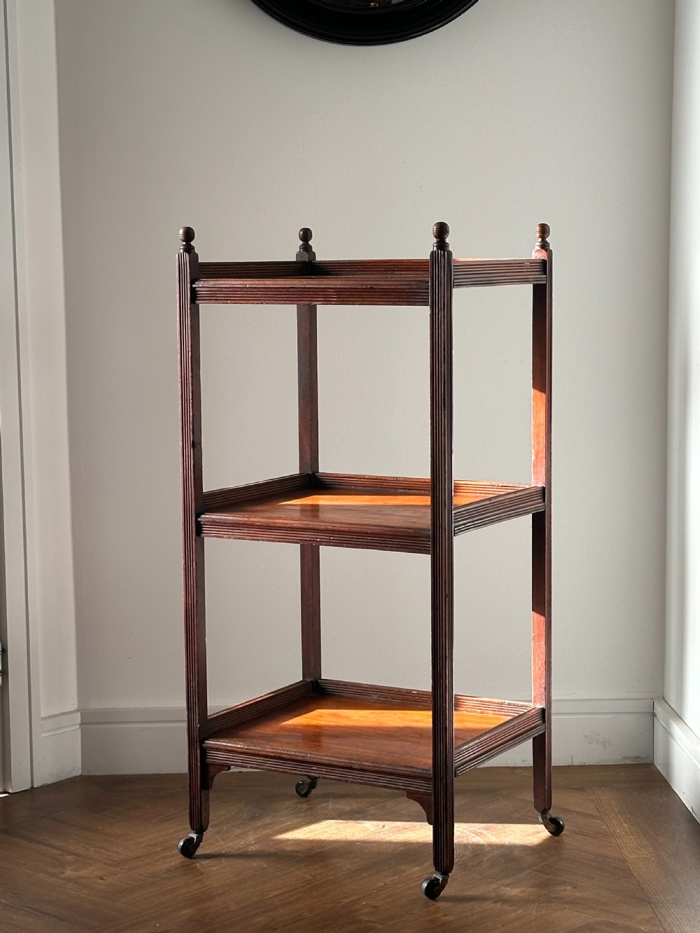 A walnut Aesthetic Movement three tier whatnot in the manner of E.W Godwin