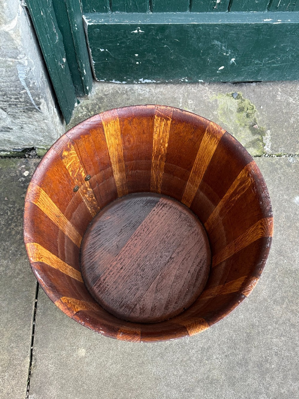 An antique Scottish coopered wooden peat bucket with alternating light and dark staves bound by three brass hoops. View VI