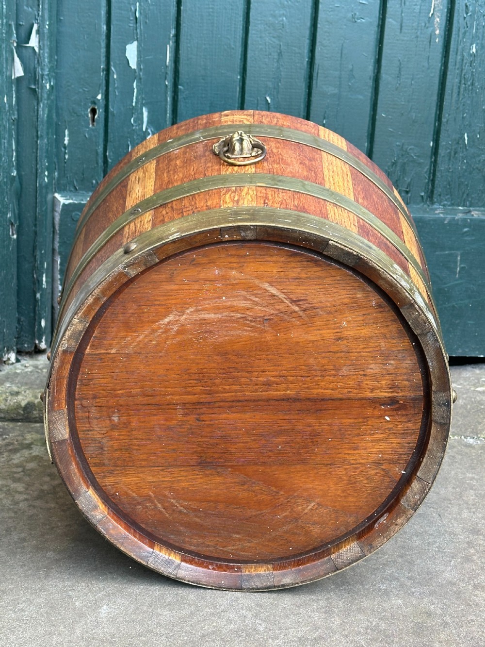 An antique Scottish coopered wooden peat bucket with alternating light and dark staves bound by three brass hoops. View V