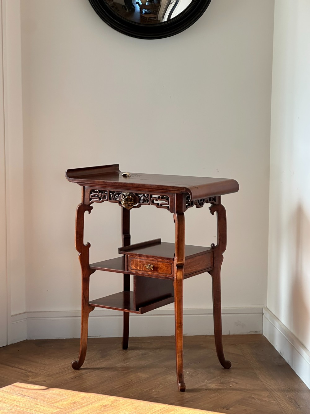 A late 19th-century French Japonisme side table featuring a curved pagoda top, open asymmetrical shelves, pierced wood carving, and a gilt-bronze motif. View III