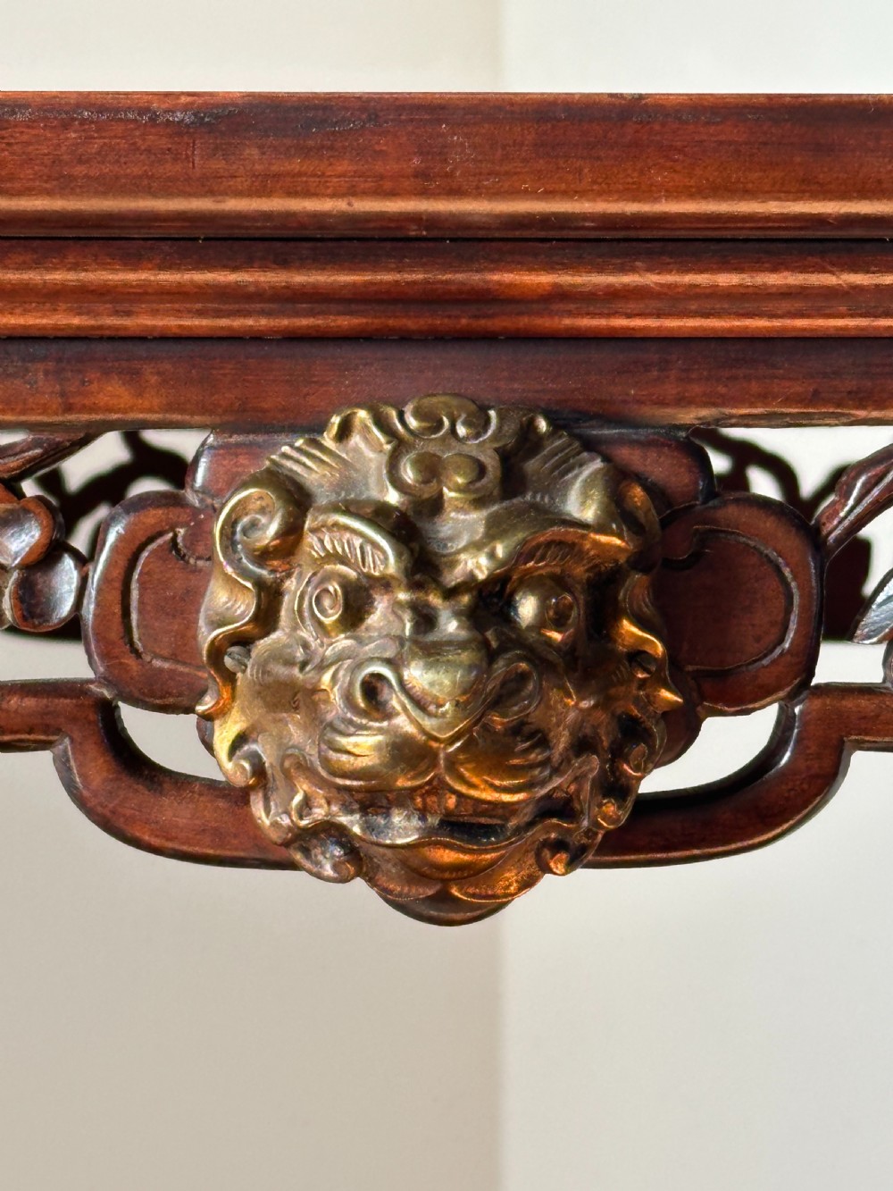 A late 19th-century French Japonisme side table featuring a curved pagoda top, open asymmetrical shelves, pierced wood carving, and a gilt-bronze motif. View IV
