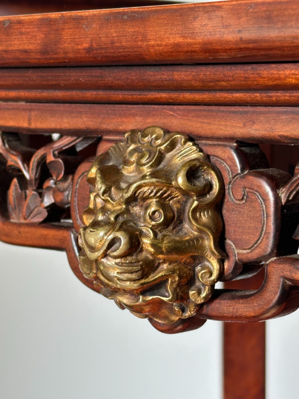 A late 19th-century French Japonisme side table featuring a curved pagoda top, open asymmetrical shelves, pierced wood carving, and a gilt-bronze motif. View VI