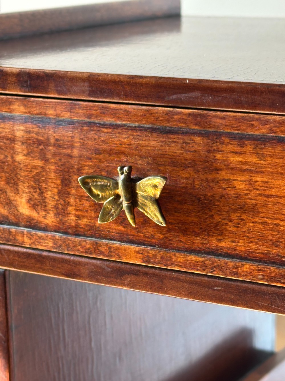 A late 19th-century French Japonisme side table featuring a curved pagoda top, open asymmetrical shelves, pierced wood carving, and a gilt-bronze motif. View VII