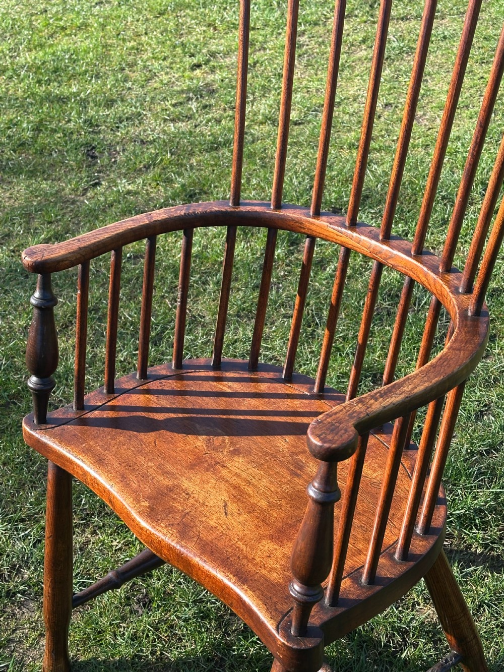 A Scottish Darvel Windsor armchair featuring a high spindle back, bentwood crest rail, curved armrests on turned supports, and a solid wood seat. View II