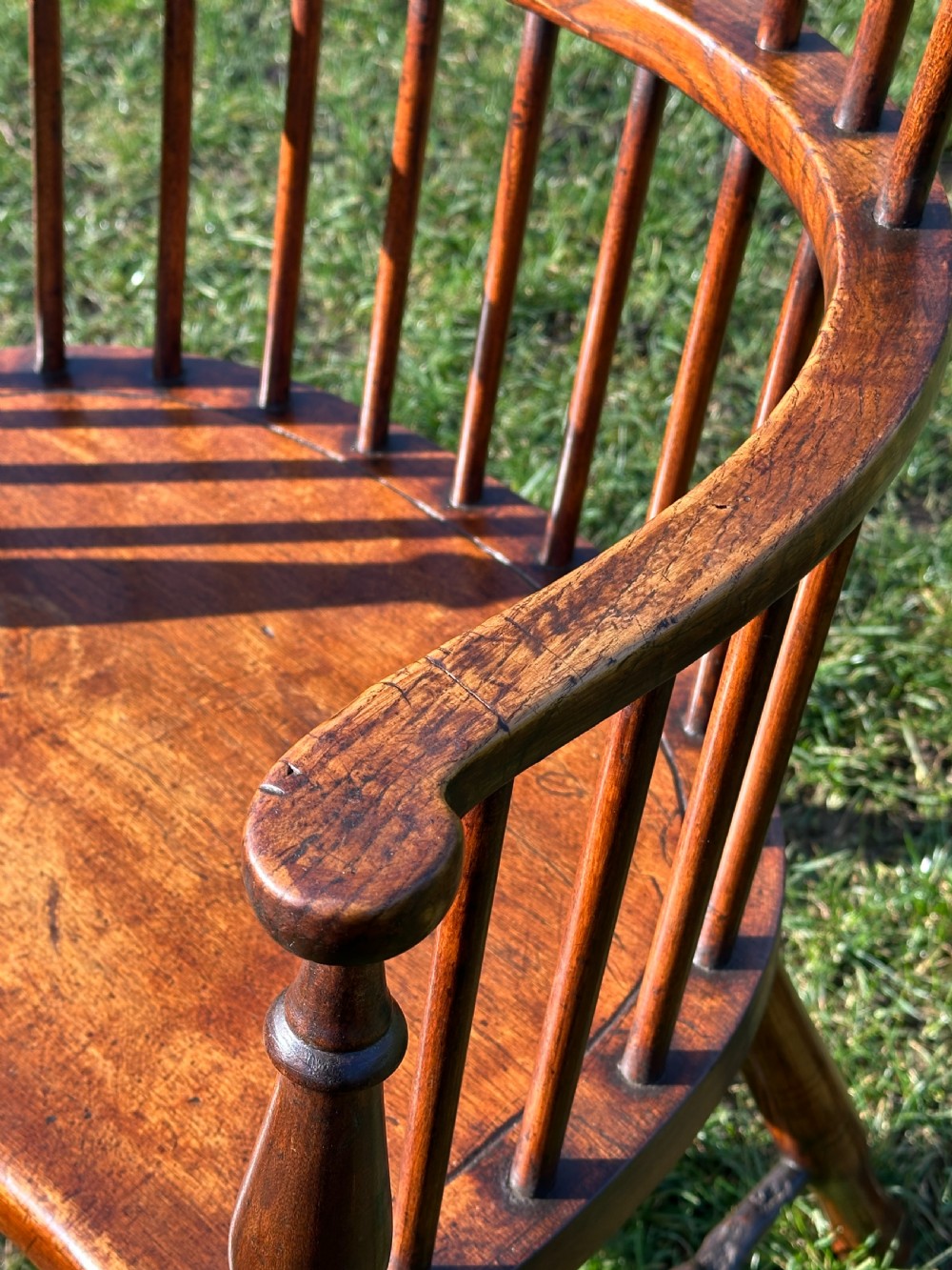 A Scottish Darvel Windsor armchair featuring a high spindle back, bentwood crest rail, curved armrests on turned supports, and a solid wood seat. View III