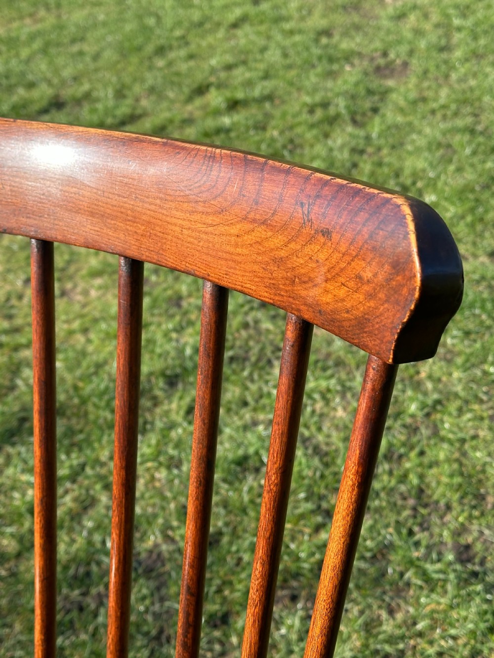 A Scottish Darvel Windsor armchair featuring a high spindle back, bentwood crest rail, curved armrests on turned supports, and a solid wood seat. View IV