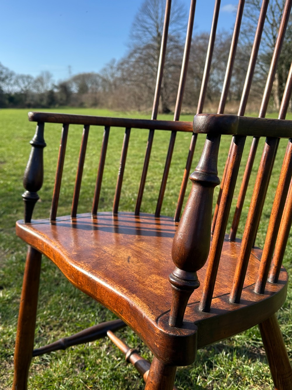 A Scottish Darvel Windsor armchair featuring a high spindle back, bentwood crest rail, curved armrests on turned supports, and a solid wood seat. View VI