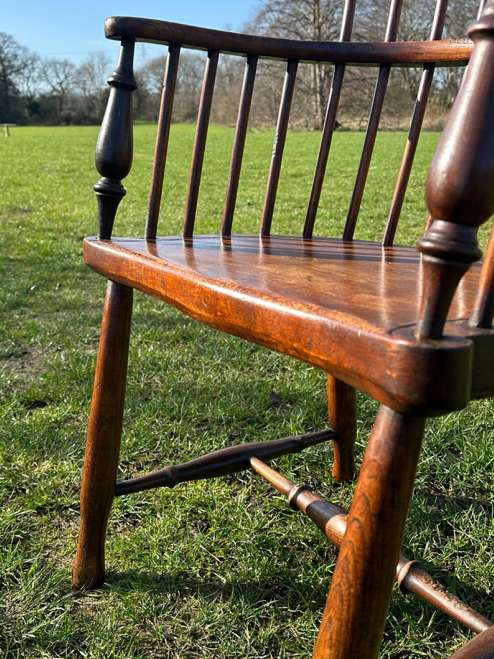 A Scottish Darvel Windsor armchair featuring a high spindle back, bentwood crest rail, curved armrests on turned supports, and a solid wood seat. View VII