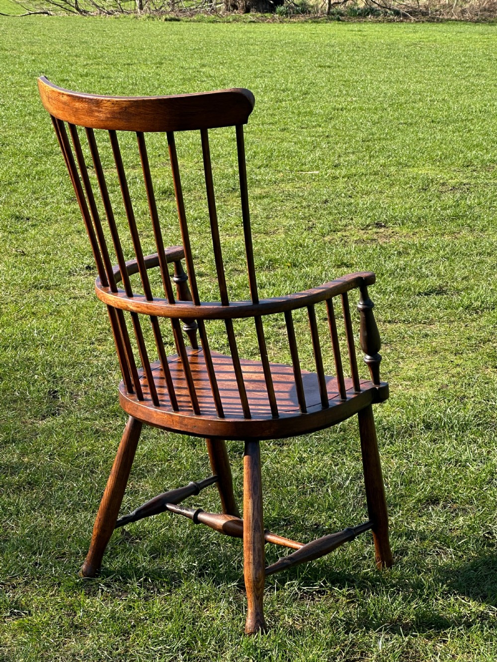 A Scottish Darvel Windsor armchair featuring a high spindle back, bentwood crest rail, curved armrests on turned supports, and a solid wood seat. View VIII