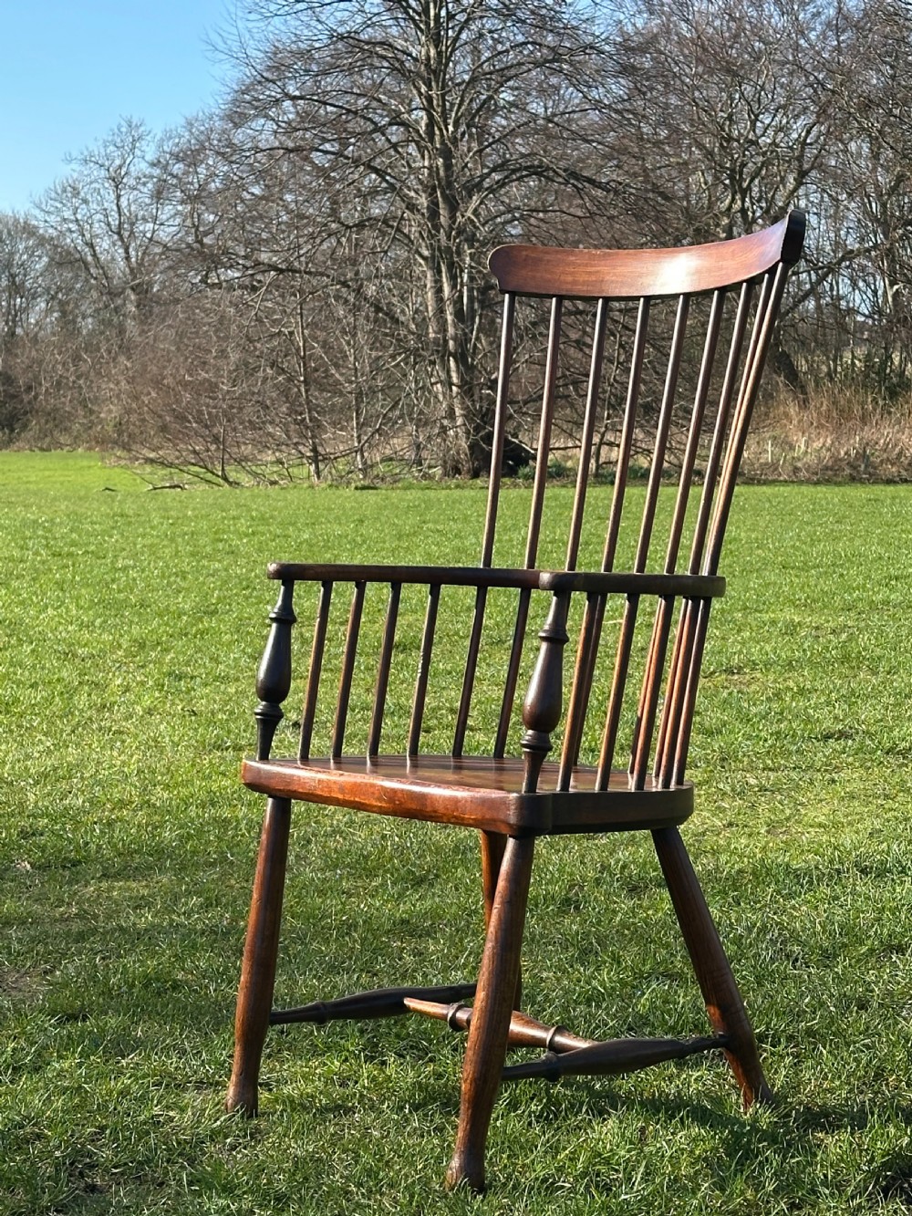 A Scottish Darvel Windsor armchair featuring a high spindle back, bentwood crest rail, curved armrests on turned supports, and a solid wood seat. View IX