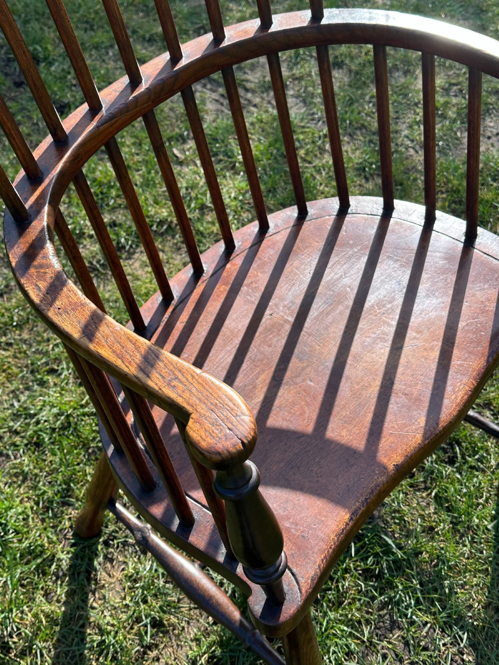 A Scottish Darvel Windsor armchair featuring a high spindle back, bentwood crest rail, curved armrests on turned supports, and a solid wood seat. View XI