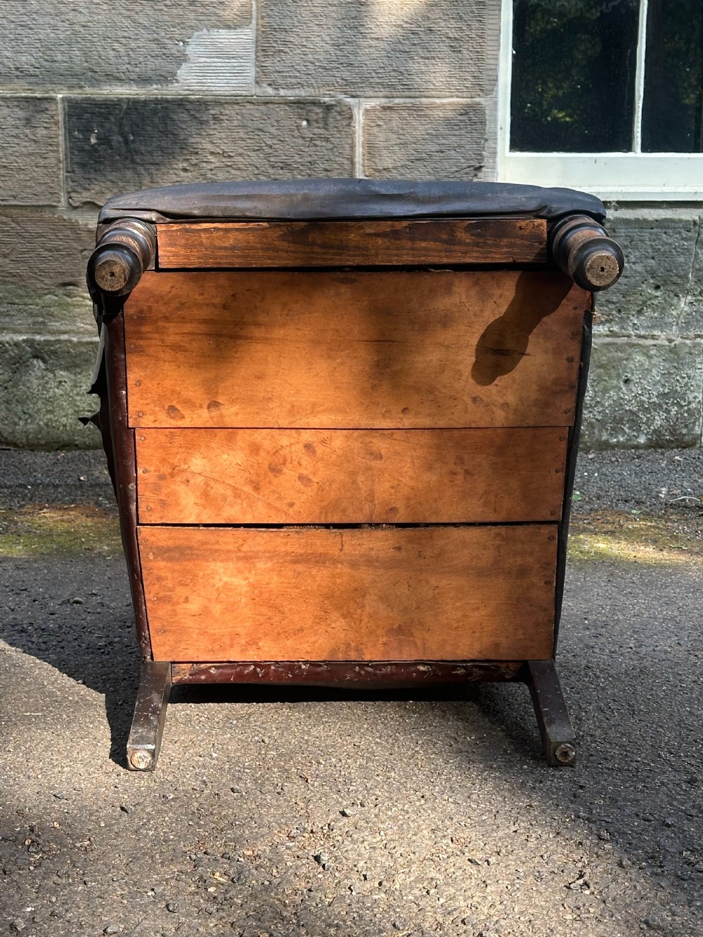 A Victorian library armchair upholstered in worn dark brown leather featuring a buttoned backrest, padded arms, and turned wooden front legs. View II