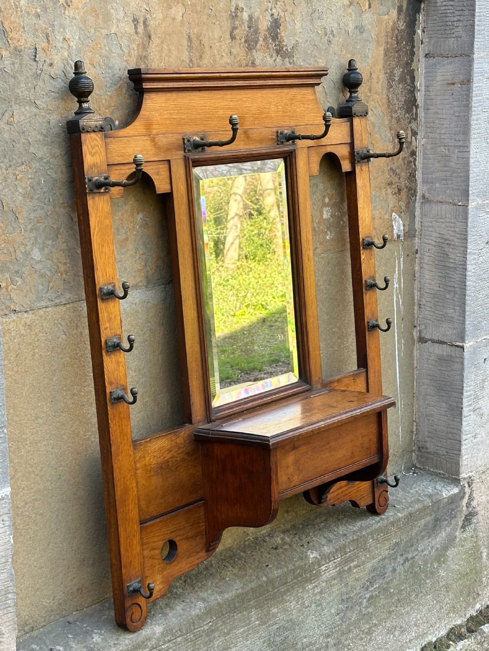 Attributed to James Shoolbred, an Aesthetic Movement oak and brass-mounted hall rack