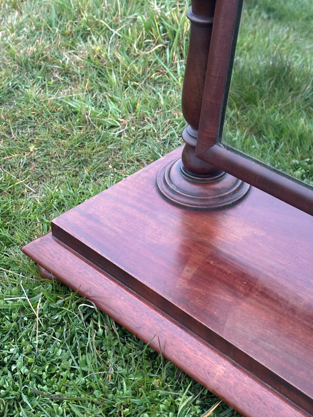 A mid-19th century mahogany dressing mirror featuring turned side supports, finials, and a moulded rectangular plinth base. View III