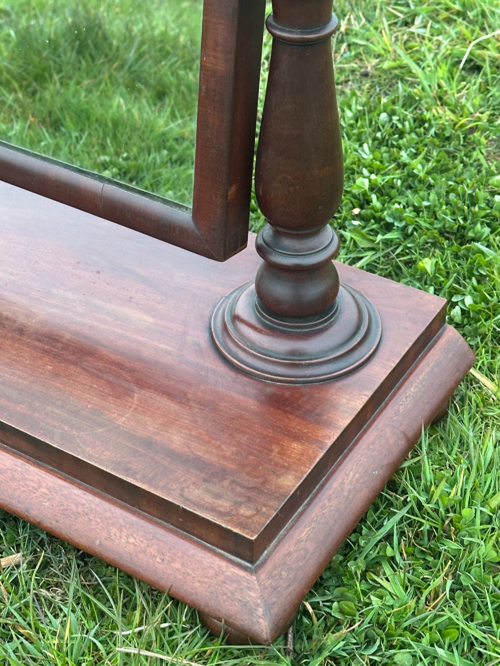 A mid-19th century mahogany dressing mirror featuring turned side supports, finials, and a moulded rectangular plinth base. View IV