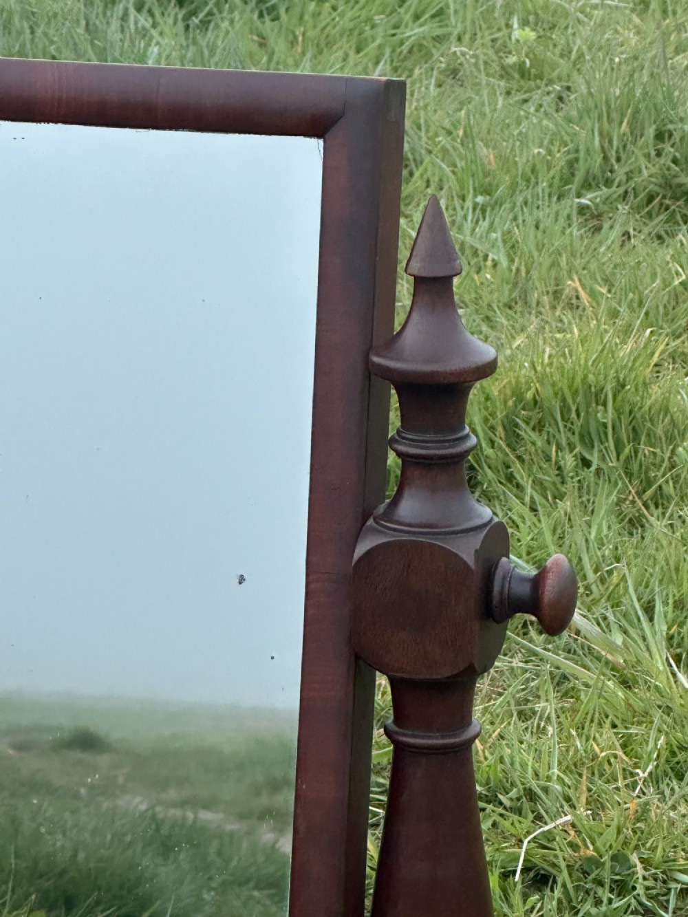 A mid-19th century mahogany dressing mirror featuring turned side supports, finials, and a moulded rectangular plinth base. View V