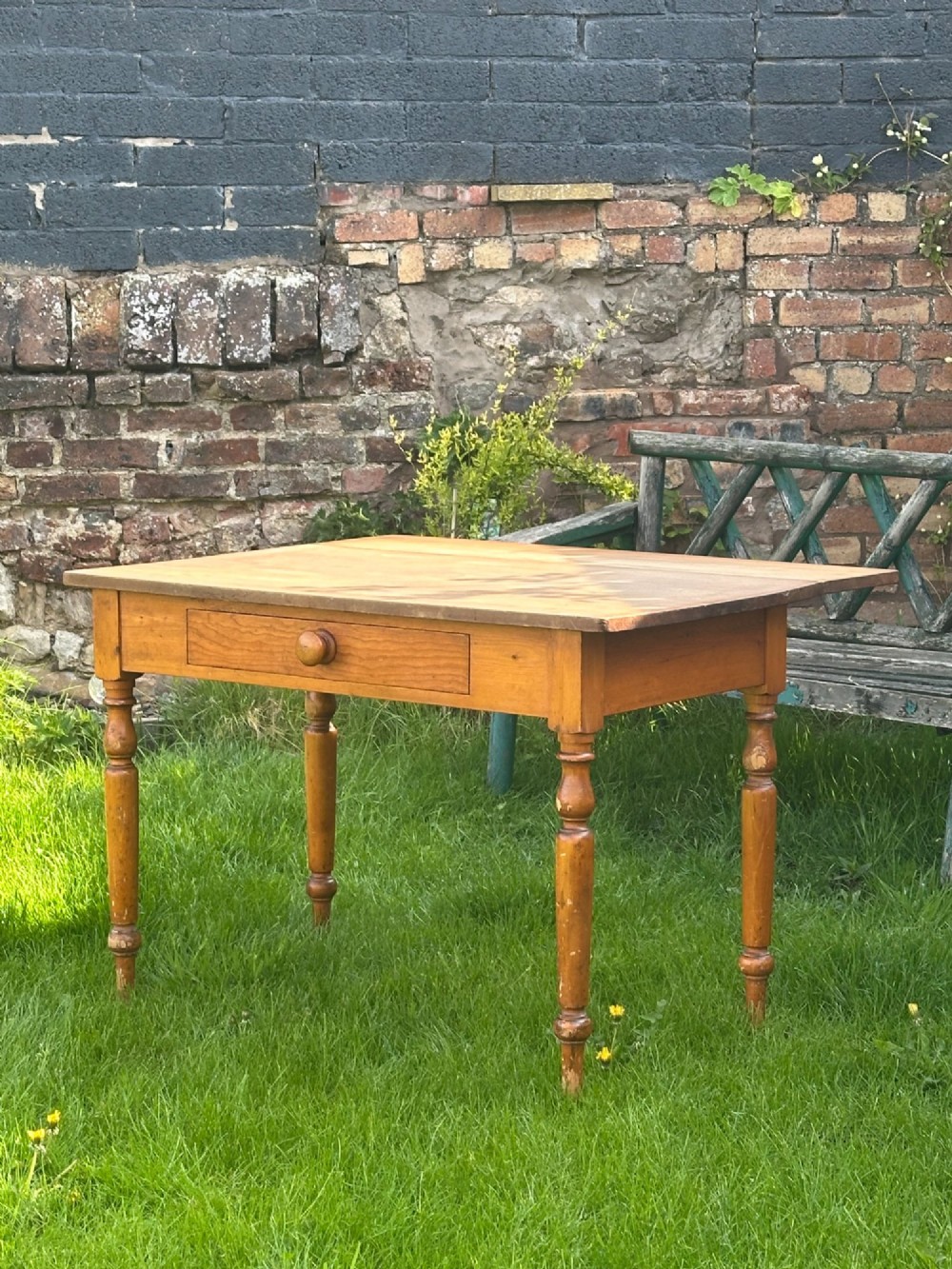 A 19th-century pine kitchen preparation table featuring turned legs, a single frieze drawer with a wooden knob, and a drop-leaf extension. View IV