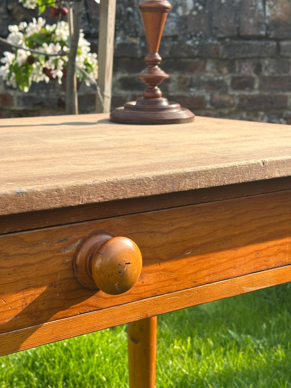 A 19th-century pine kitchen preparation table featuring turned legs, a single frieze drawer with a wooden knob, and a drop-leaf extension. View V