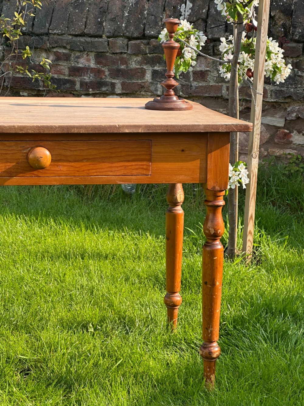 A 19th-century pine kitchen preparation table featuring turned legs, a single frieze drawer with a wooden knob, and a drop-leaf extension. View VII