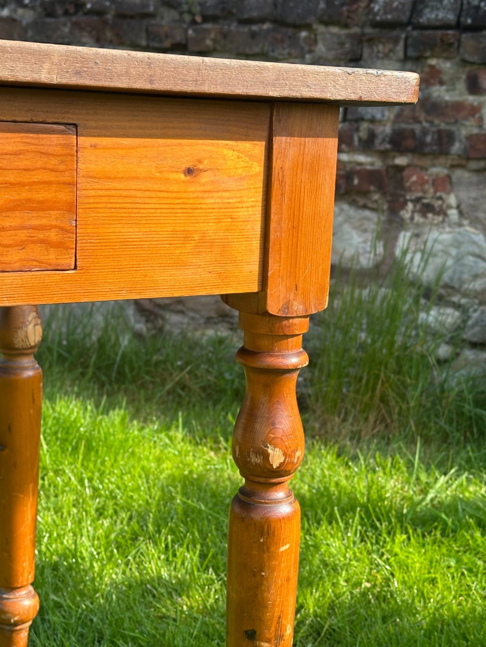 A 19th-century pine kitchen preparation table featuring turned legs, a single frieze drawer with a wooden knob, and a drop-leaf extension. View XIII