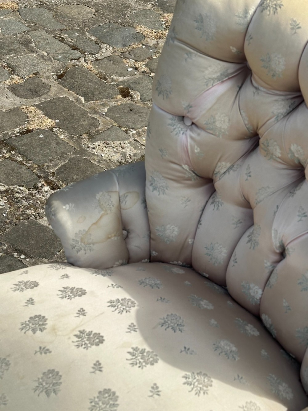 A Victorian button-back drawing room chair with cream damask upholstery, ebonised turned legs, a spindled stretcher gallery, and brass casters. View II