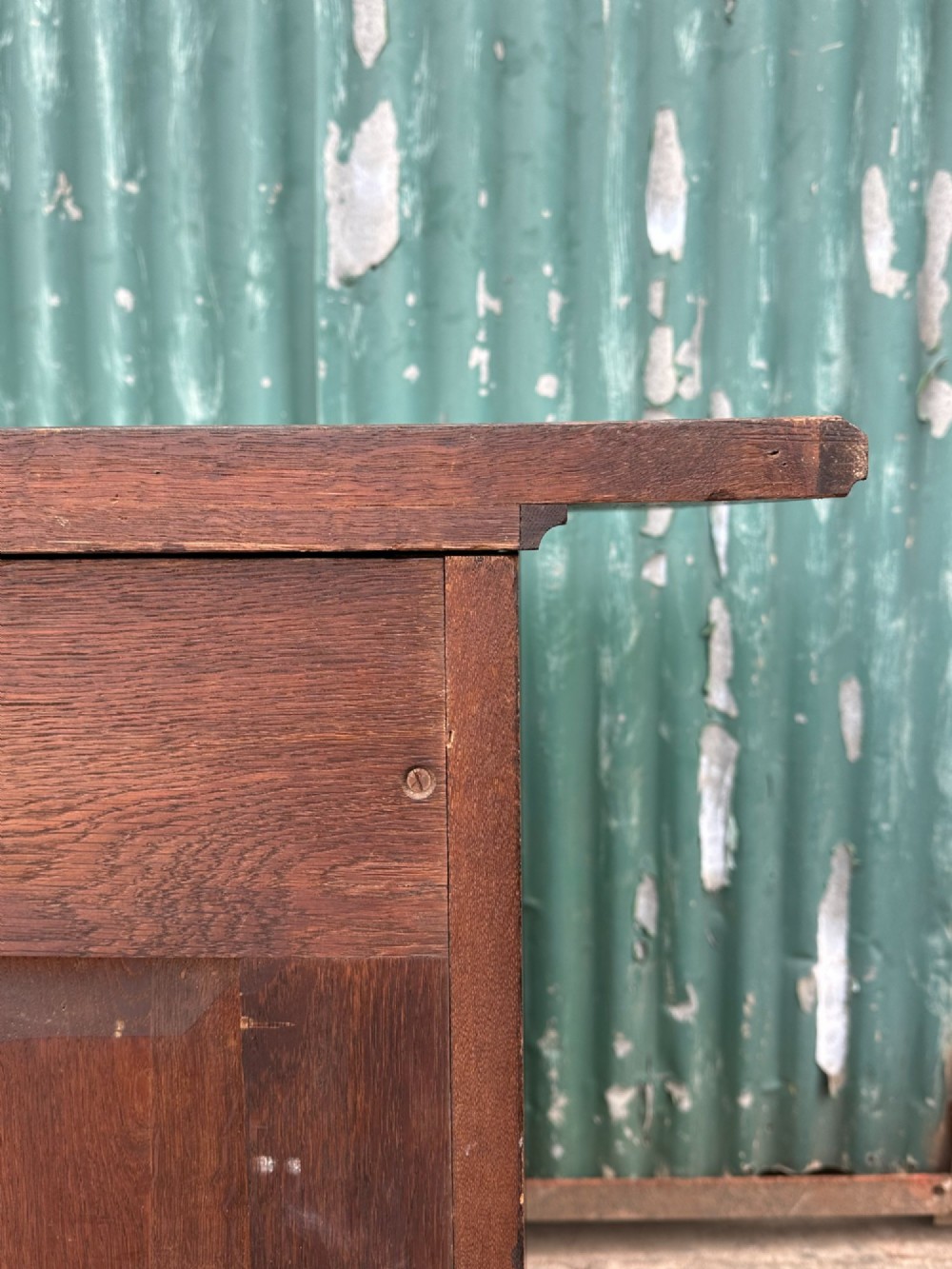 A dark oak Arts and Crafts side cabinet with two upper drawers, lattice glazed double doors, and decorative brass mounts. View VIII