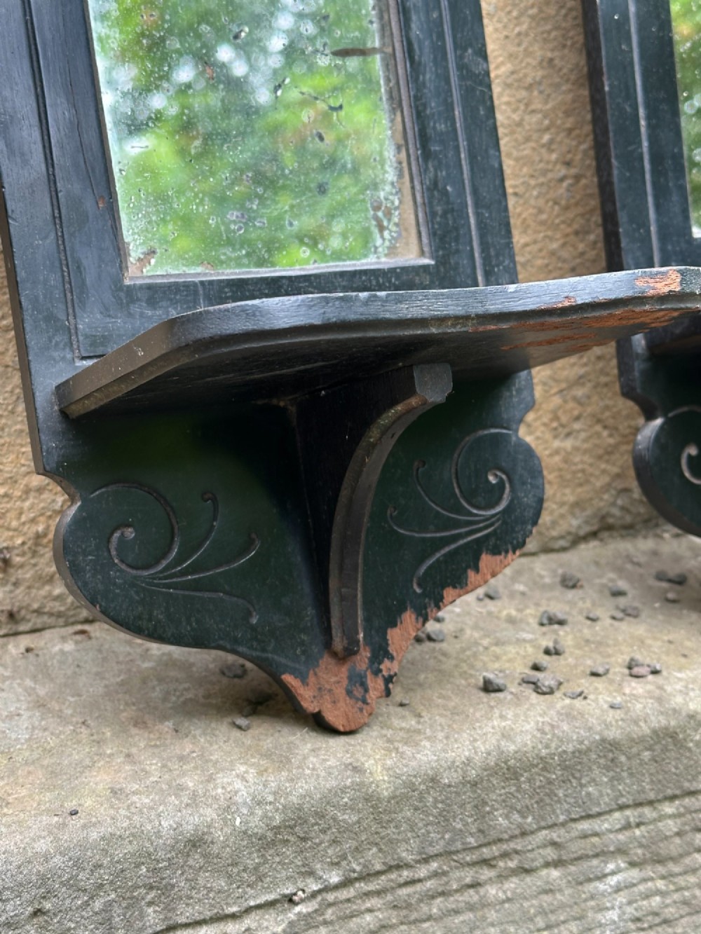 A pair of late 19th-century black ebonised wooden wall girandoles with arched mirror plates, incised scroll detailing, and integrated shelves. View IV