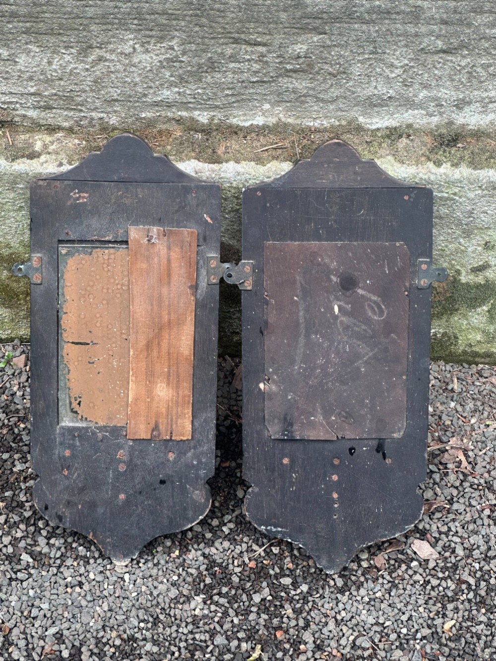 A pair of late 19th-century black ebonised wooden wall girandoles with arched mirror plates, incised scroll detailing, and integrated shelves. View VII