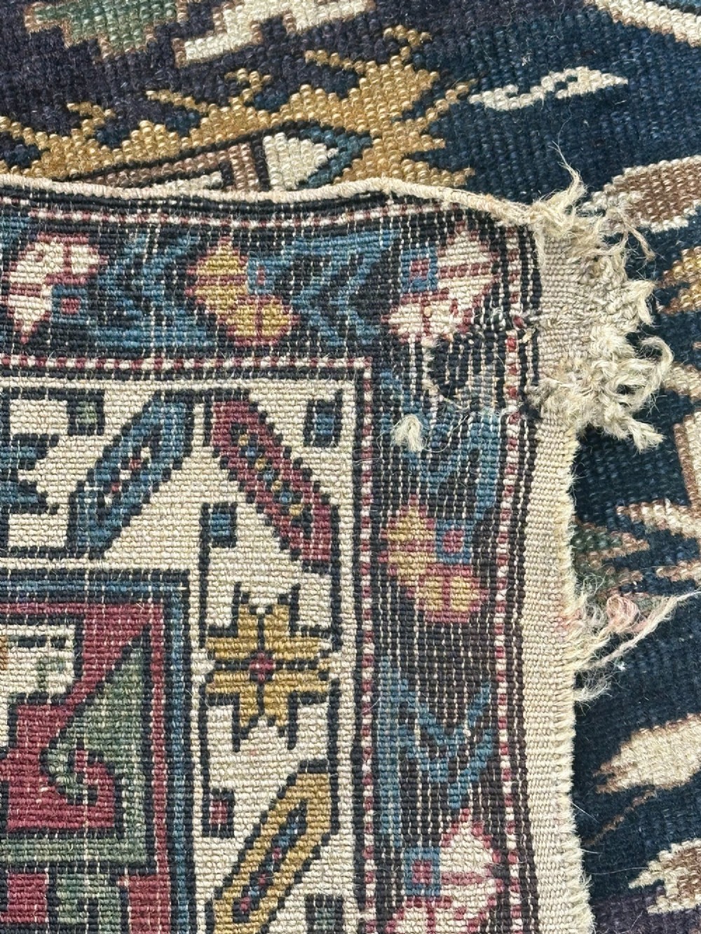 An antique East Caucasian Shirvan rug featuring a dark navy blue field filled with geometric medallions, stylized bird motifs, and multi-band patterned borders. View VI