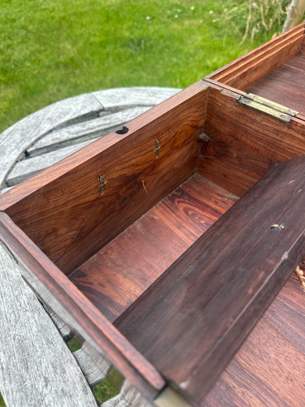 A rectangular reddish-brown padouk wood deed box featuring brass corner mounts, a central keyhole escutcheon, and brass side carrying handles. View IV