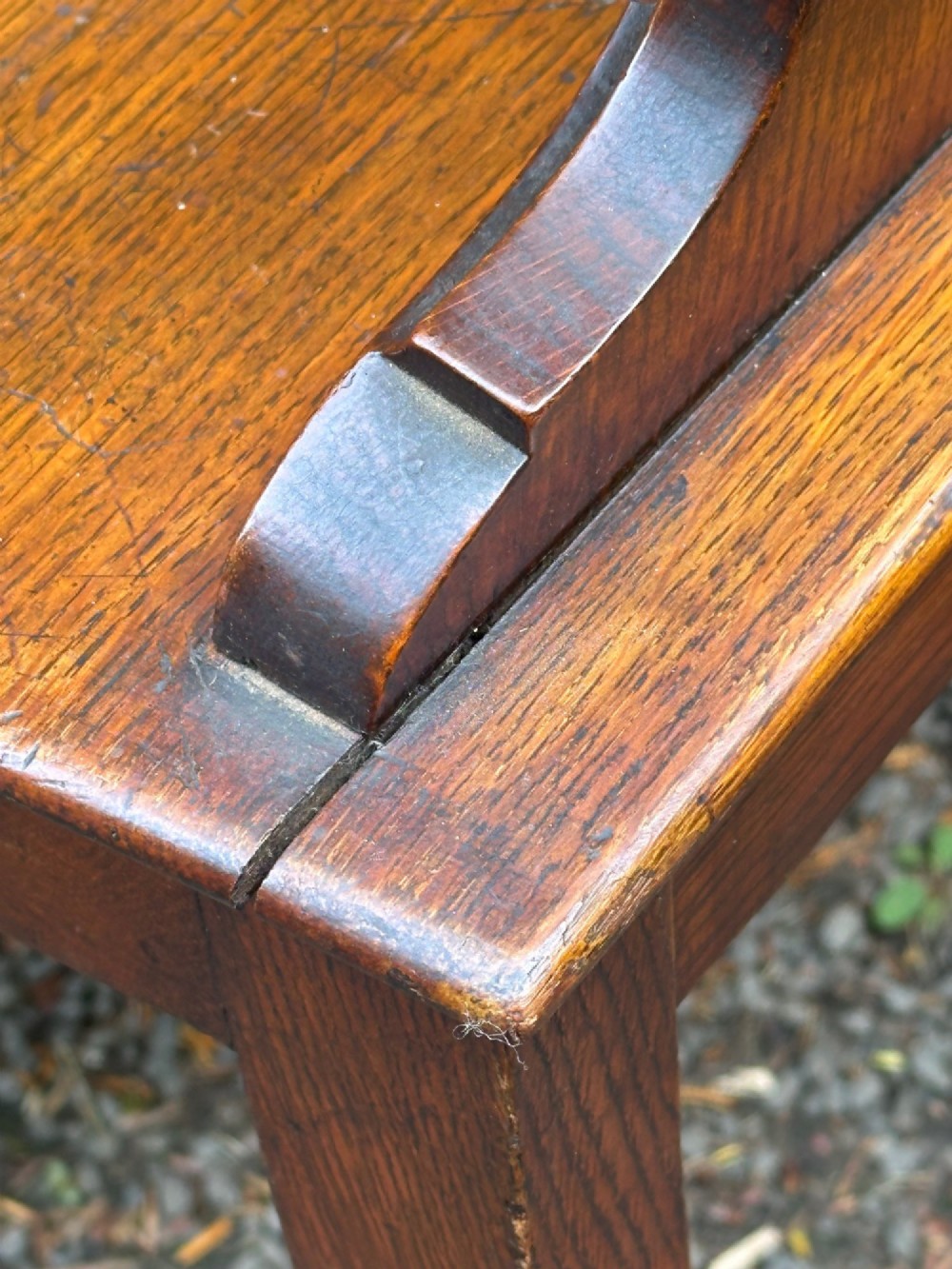 Victorian carved oak hall chair featuring a round carved backrest with a central shield motif, turned front legs, and a solid wooden seat. View VI