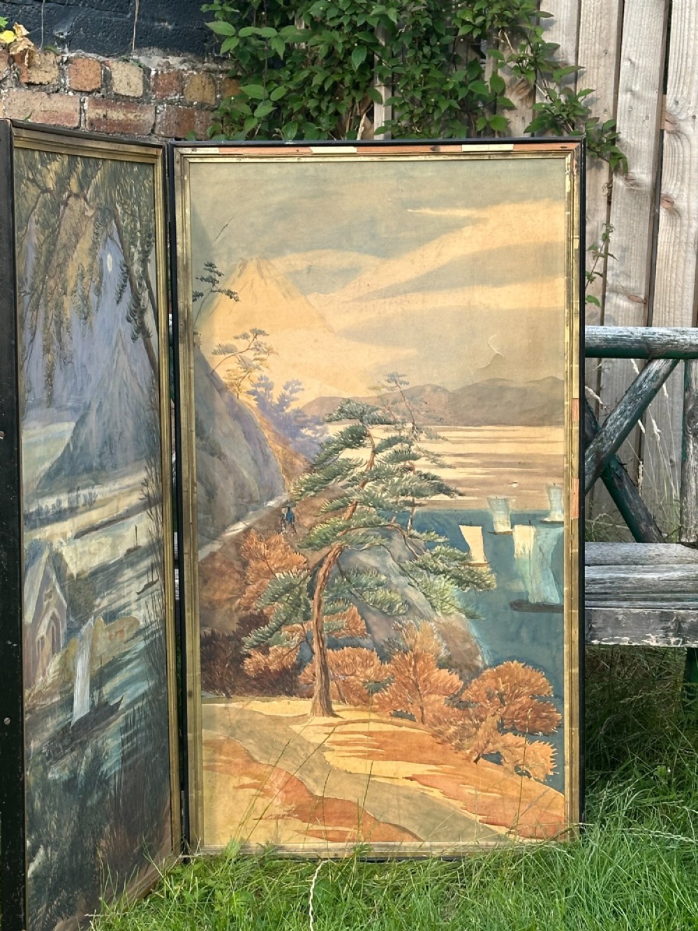 A late nineteenth-century two-panel folding screen featuring hand-painted Japanese coastal and mountainous landscapes framed in dark wood. View XIII