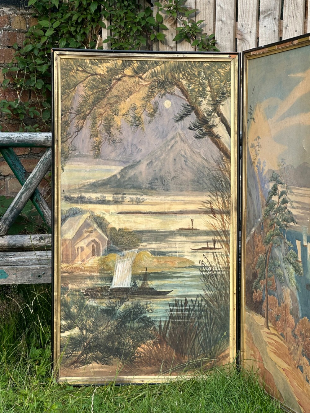 A late nineteenth-century two-panel folding screen featuring hand-painted Japanese coastal and mountainous landscapes framed in dark wood. View XIV
