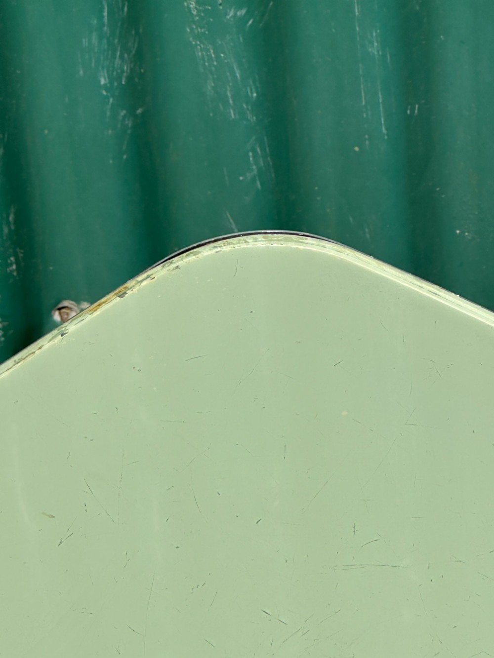 A 1930s Art Deco side table with a sage green rectangular top supported by continuous chrome tubular steel legs. View IV