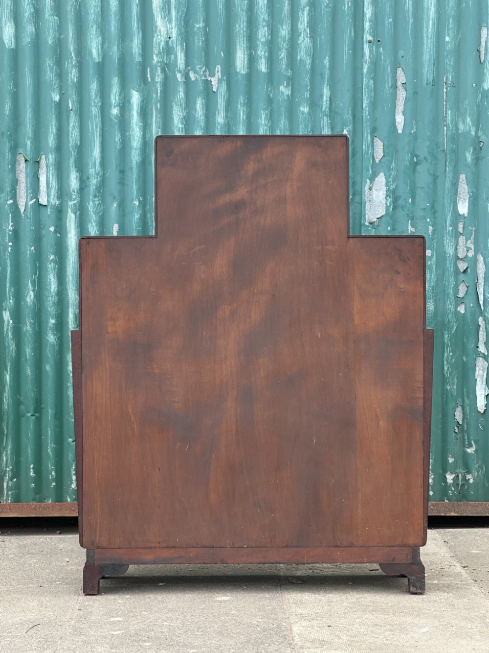 An architectural 1930s Art Deco cabinet made of warm brown walnut wood with a tall central glazed door flanked by lower cupboard doors and open alcoves. View VIII