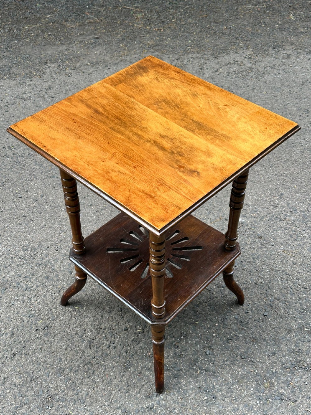 An Anglo-Japanese two-tier wooden occasional table featuring turned spindle legs, a square top, and a pierced lower shelf. View IV