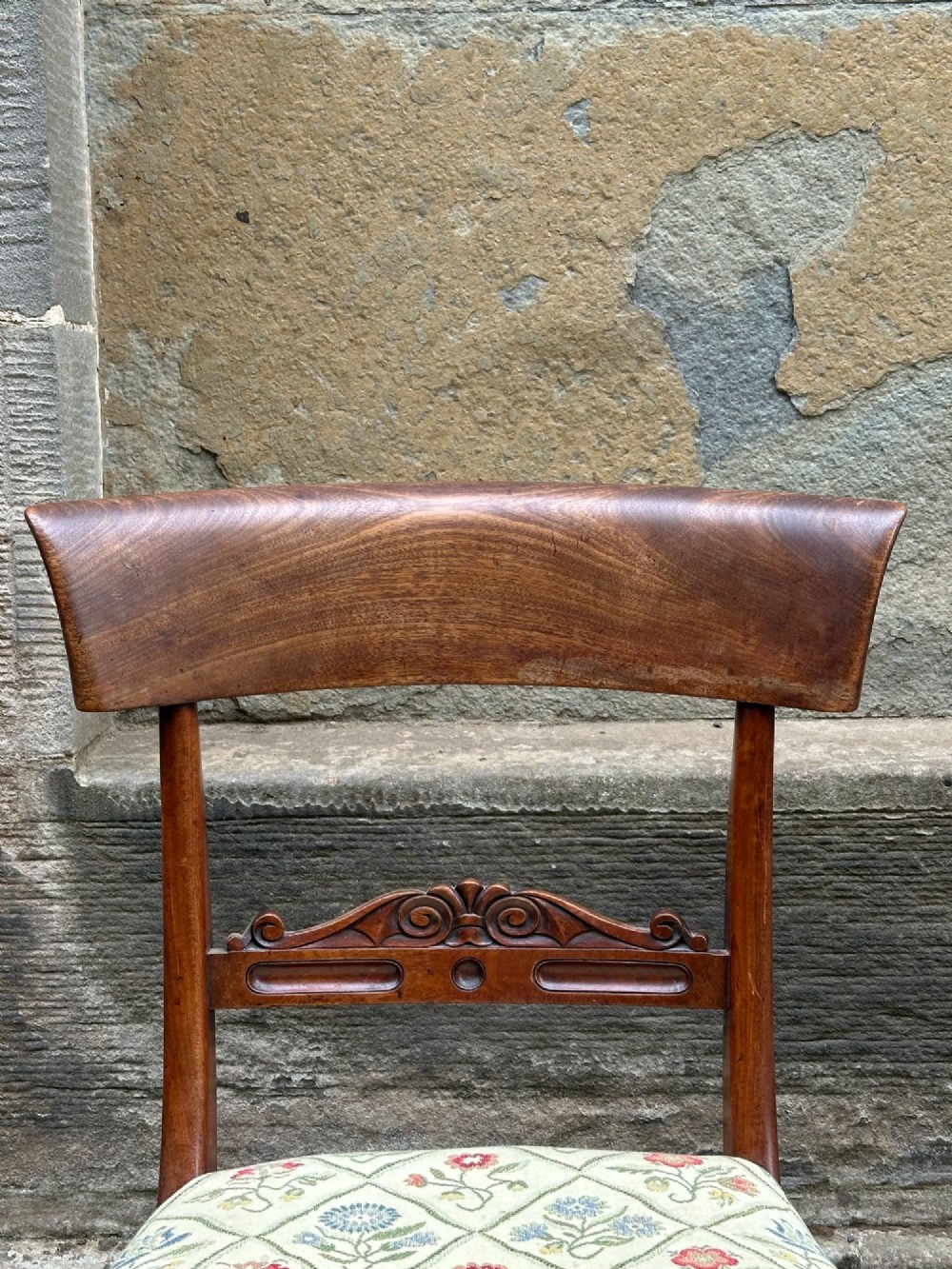 A pair of Scottish Regency mahogany side chairs with curved top rails, carved back splats, upholstered seats, and turned front legs on castors. View IV