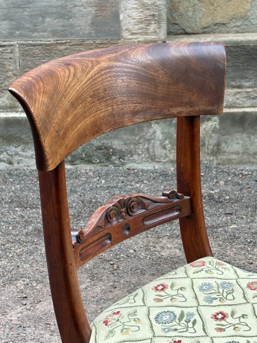 A pair of Scottish Regency mahogany side chairs with curved top rails, carved back splats, upholstered seats, and turned front legs on castors. View VI