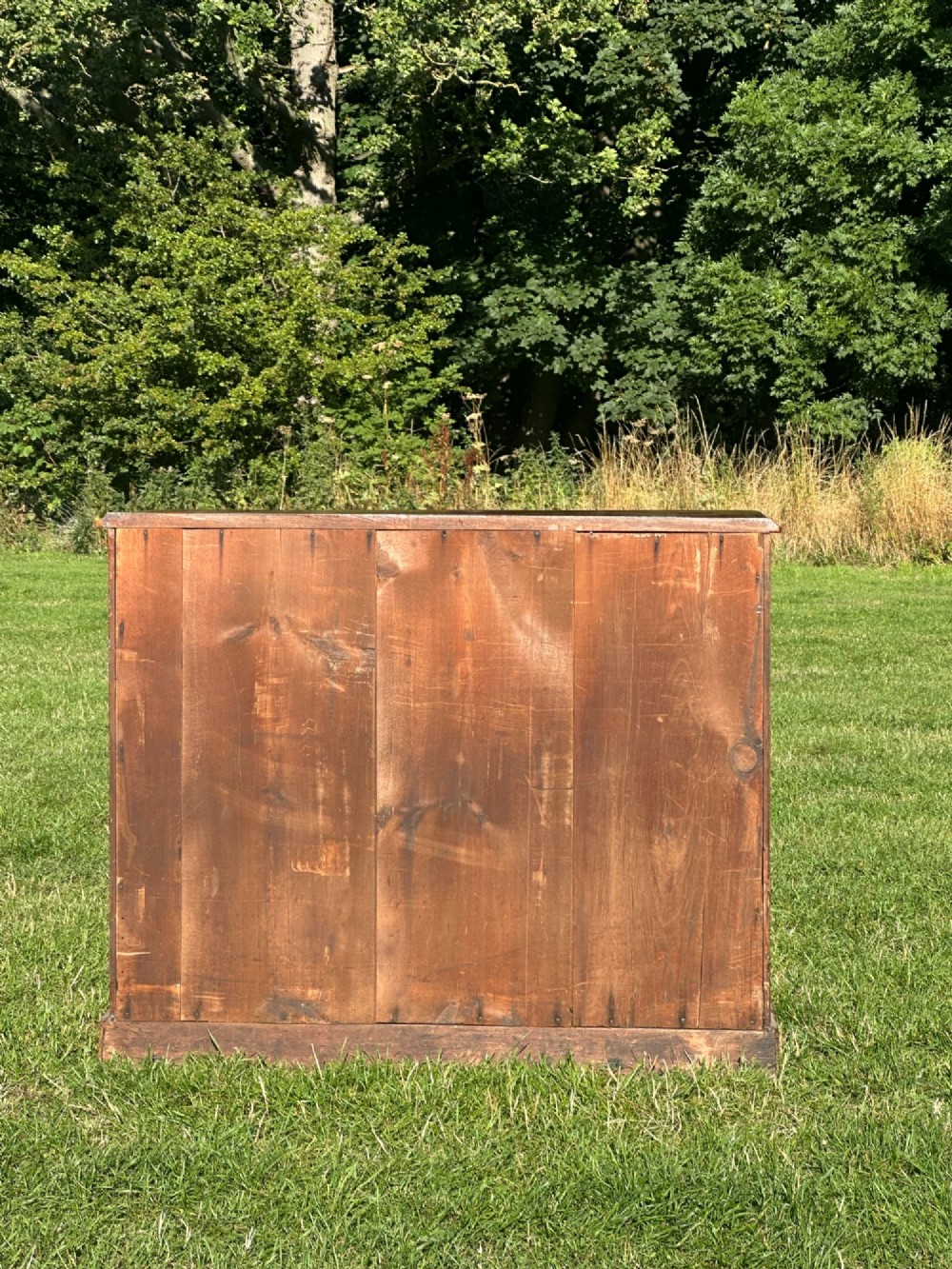 A small Victorian flame mahogany Scotch chest of drawers with two short over two long drawers, turned wooden knobs, and a serpentine top. View VII
