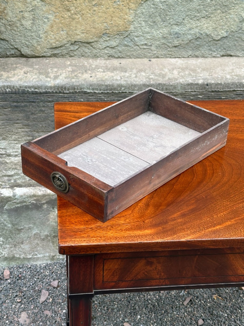 A George III mahogany side table with tapered legs, a flame mahogany veneered frieze, and a brass drawer pull. View VI